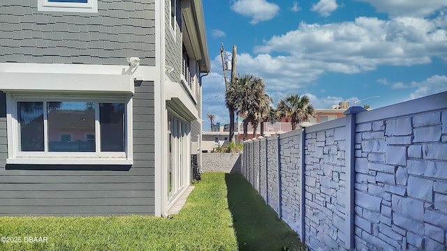 view of side of home featuring fence private yard