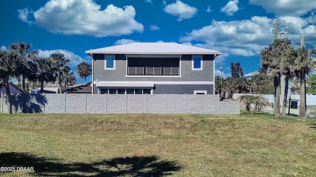 exterior space featuring a lawn and fence