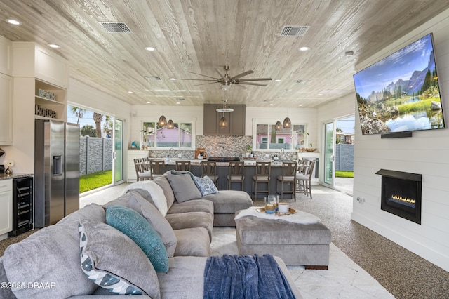 living area featuring wood ceiling, visible vents, beverage cooler, and recessed lighting