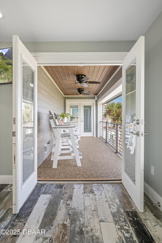 unfurnished sunroom with wood ceiling and french doors