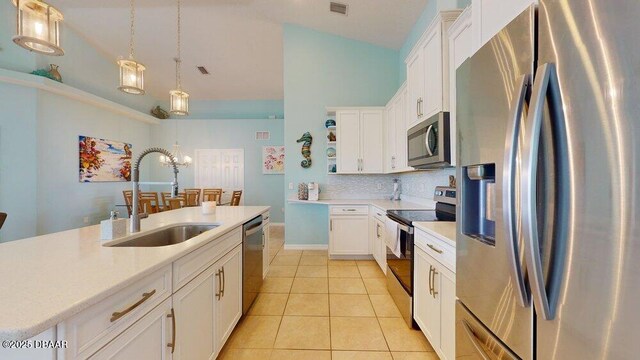 21 Curry Ct, Palm Coast, FL 32137 - kitchen featuring appliances with stainless steel finishes, a sink, light countertops, white cabinets, and light tile patterned flooring