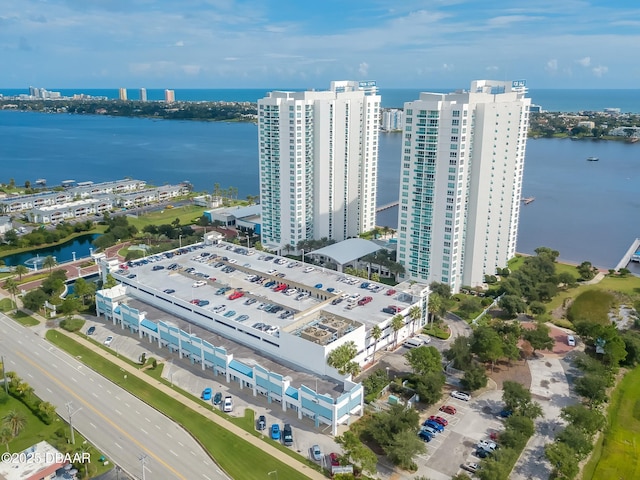 drone / aerial view featuring a view of city and a water view