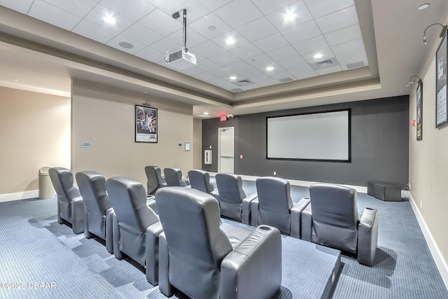 carpeted home theater with visible vents, baseboards, a drop ceiling, and a tray ceiling