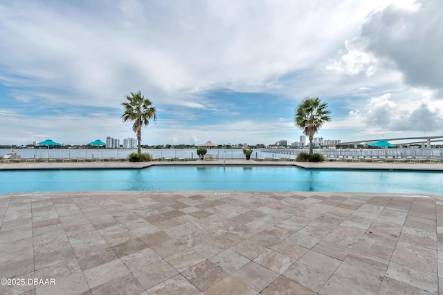 community pool featuring a patio area and fence