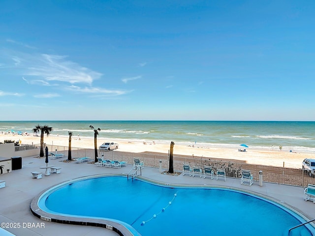 89 S Atlantic Ave Unit 103, Ormond Beach, FL 32176 - community pool featuring a patio, a view of the beach, fence, and a water view