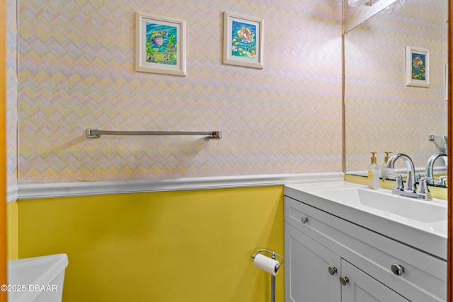 bathroom with toilet and vanity