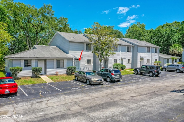 view of property with uncovered parking