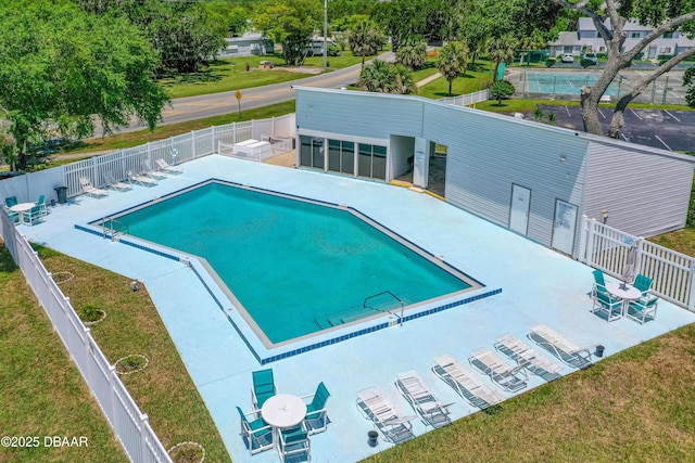community pool with a patio area