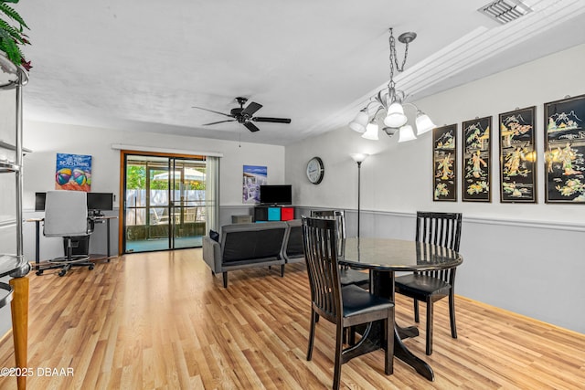 dining space featuring wood finished floors, a ceiling fan, and an office area