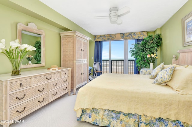 carpeted bedroom with ceiling fan and access to outside