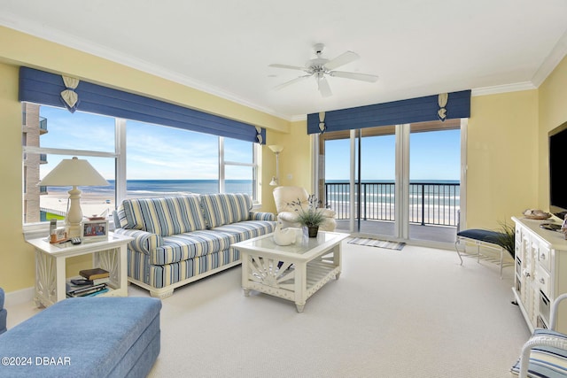 living room with ceiling fan, a water view, crown molding, and carpet floors