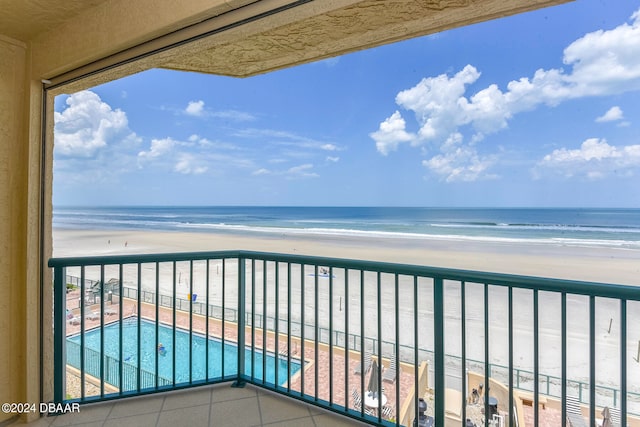 balcony with a beach view and a water view