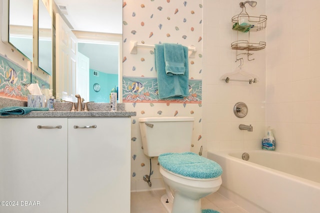 full bathroom with vanity, tile patterned floors, toilet, and tiled shower / bath