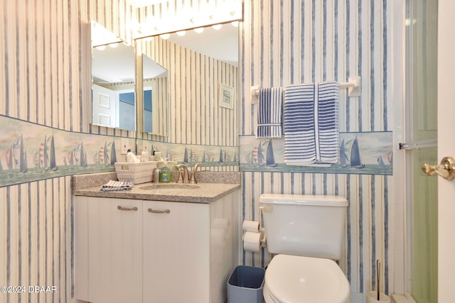 bathroom with toilet and vanity