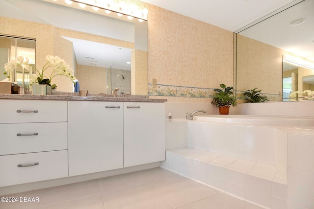 bathroom with tile patterned flooring, vanity, and independent shower and bath