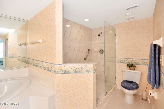 bathroom with tile patterned floors, toilet, and plus walk in shower