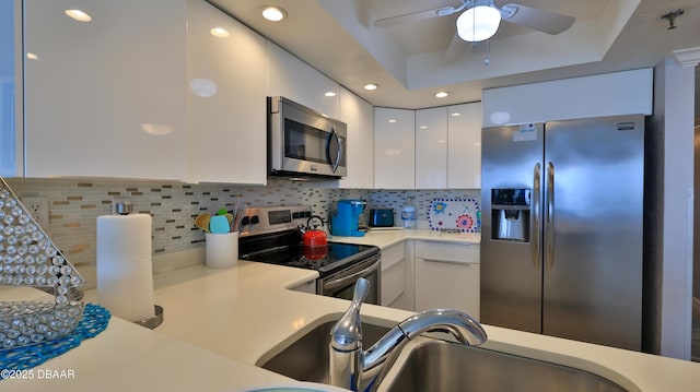 4139 S Atlantic Ave Unit B204, New Smyrna Beach, FL 32169 - kitchen with appliances with stainless steel finishes, white cabinetry, light countertops, modern cabinets, and ceiling fan