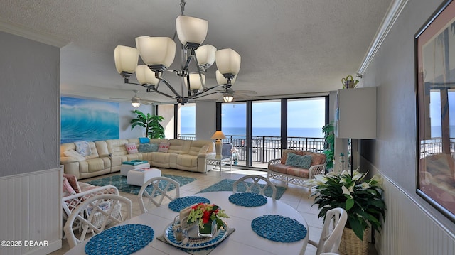 4139 S Atlantic Ave Unit B204, New Smyrna Beach, FL 32169 - tiled dining room with a textured ceiling, a water view, crown molding, a chandelier, and expansive windows