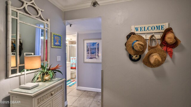 4139 S Atlantic Ave Unit B204, New Smyrna Beach, FL 32169 - hall featuring crown molding and light tile patterned floors