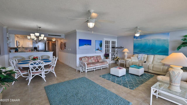 4139 S Atlantic Ave Unit B204, New Smyrna Beach, FL 32169 - tiled living room featuring a chandelier, ornamental molding, a ceiling fan, a textured ceiling, and wainscoting