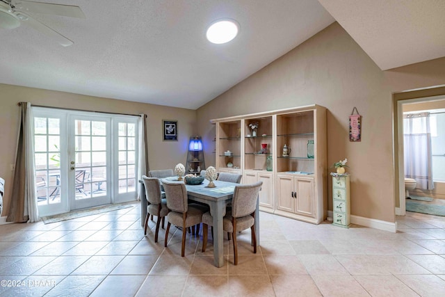 tiled dining space featuring a textured ceiling, vaulted ceiling, plenty of natural light, and ceiling fan