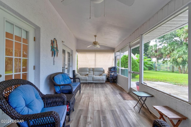 sunroom / solarium with a ceiling fan