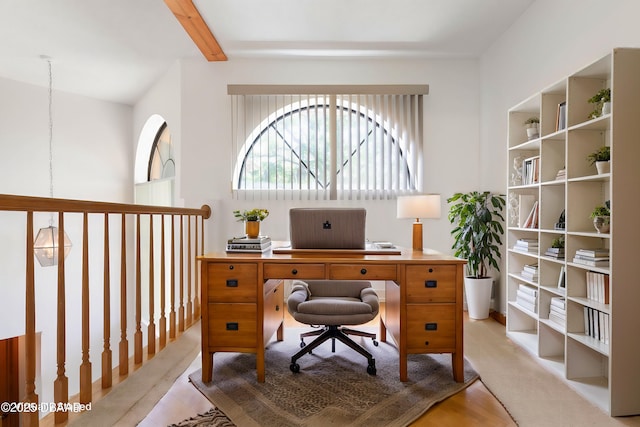 office area with beamed ceiling and light wood-style flooring