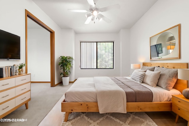 bedroom with baseboards, ceiling fan, and light colored carpet