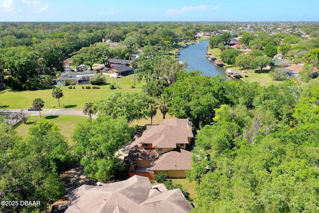 birds eye view of property featuring a water view and a view of trees