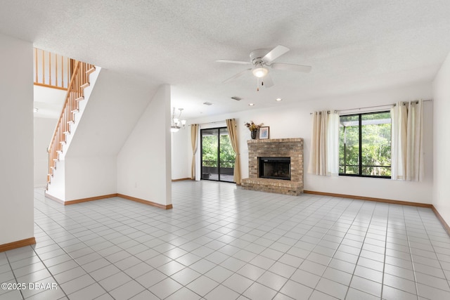 unfurnished living room featuring a healthy amount of sunlight, tile patterned flooring, and ceiling fan with notable chandelier