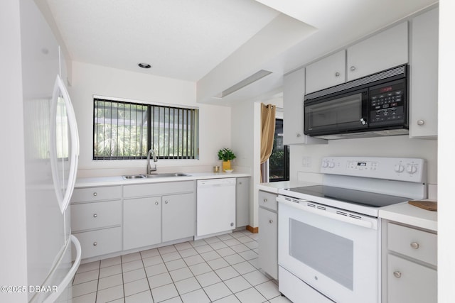 kitchen with light tile patterned floors, white cabinets, a sink, light countertops, and white appliances