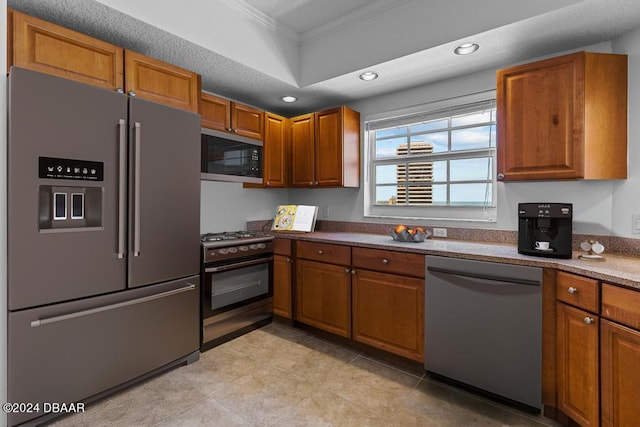 kitchen featuring appliances with stainless steel finishes and crown molding