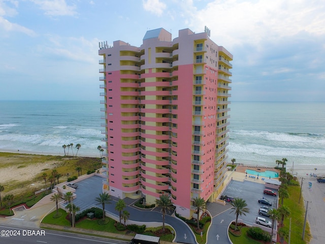 view of property with a view of the beach and a water view