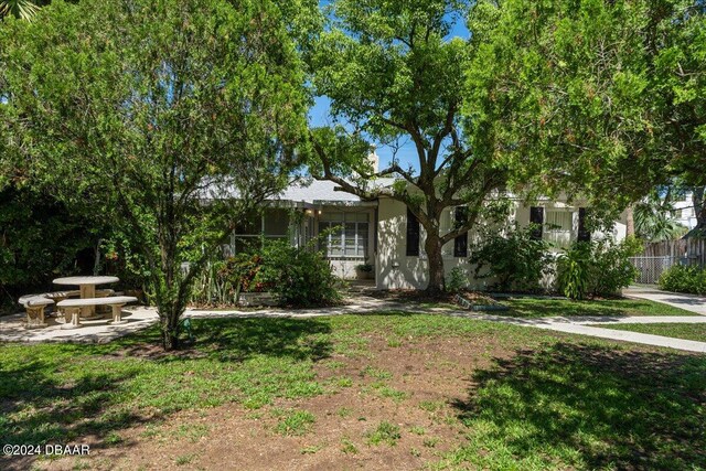 obstructed view of property with a front lawn