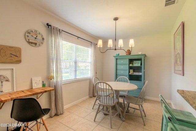 tiled dining area featuring an inviting chandelier