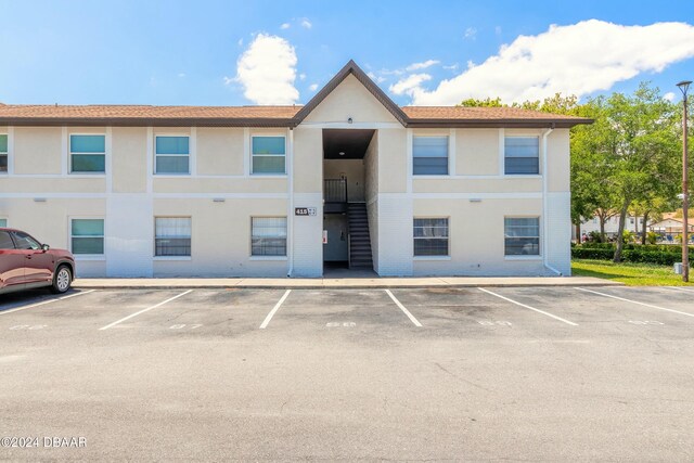 415 Banana Cay Dr Unit F, South Daytona, FL 32119 - view of building exterior featuring uncovered parking and stairs