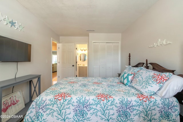 bedroom featuring connected bathroom and a closet