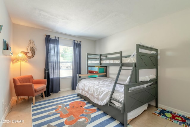 tiled bedroom with a textured ceiling