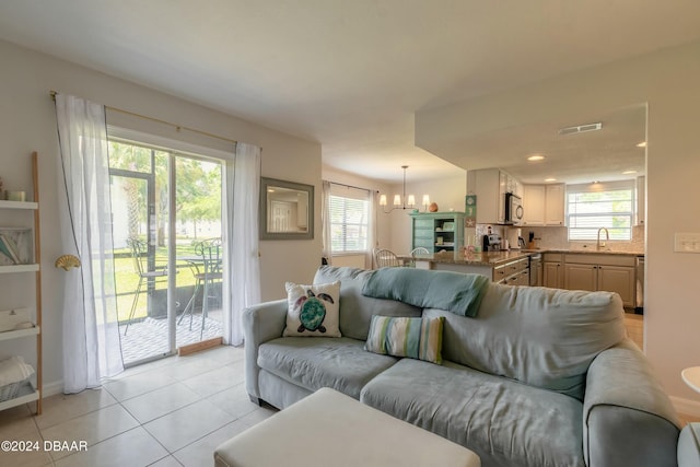 415 Banana Cay Dr Unit F, South Daytona, FL 32119 - living area with light tile patterned floors, a chandelier, plenty of natural light, and recessed lighting