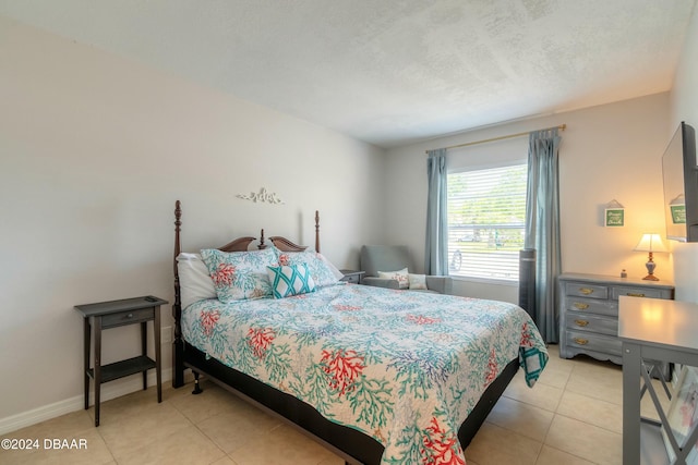 bedroom with light tile patterned flooring and a textured ceiling