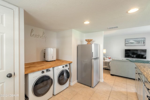 415 Banana Cay Dr Unit F, South Daytona, FL 32119 - washroom with independent washer and dryer, baseboards, light tile patterned floors, and recessed lighting