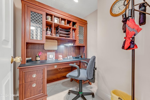 tiled office featuring a textured ceiling