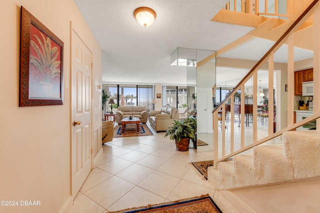 tiled foyer entrance with a textured ceiling