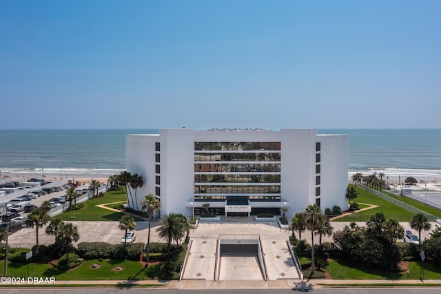 view of property featuring a beach view and a water view