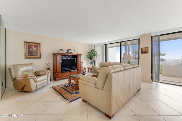 901 S Atlantic Ave Unit 102, Ormond Beach, FL 32176 - living area featuring a textured ceiling and light tile patterned floors