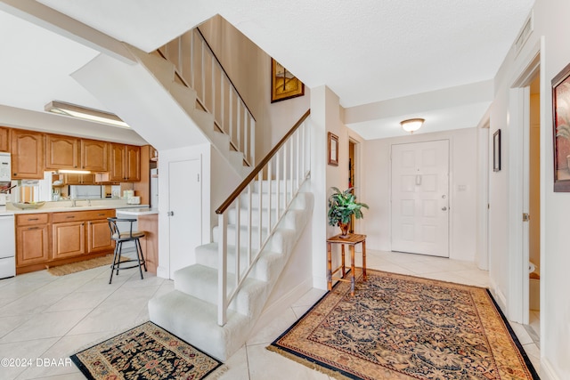 tiled foyer with sink