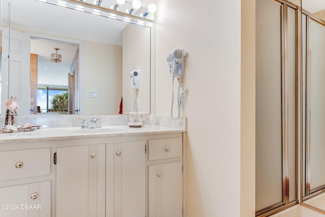 bathroom featuring vanity and a shower with door