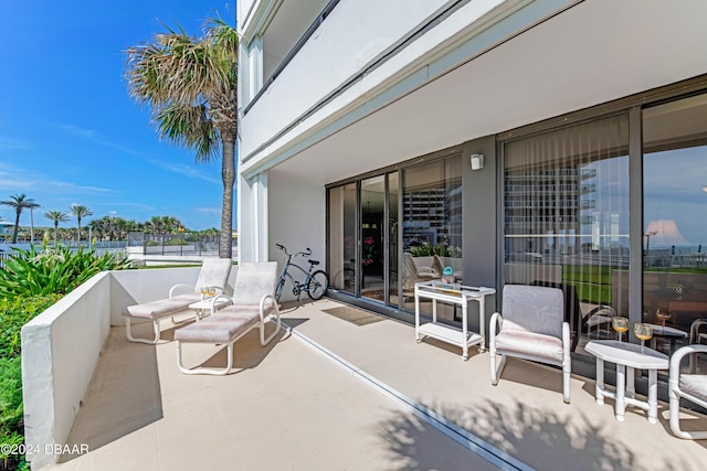 901 S Atlantic Ave Unit 102, Ormond Beach, FL 32176 - view of patio featuring a balcony