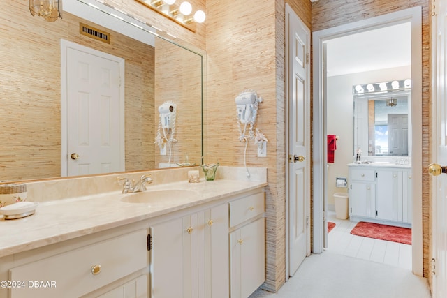 bathroom with tile patterned flooring, vanity, and toilet