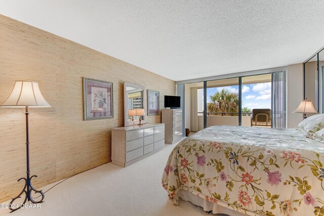 901 S Atlantic Ave Unit 102, Ormond Beach, FL 32176 - carpeted bedroom with a textured ceiling and access to exterior
